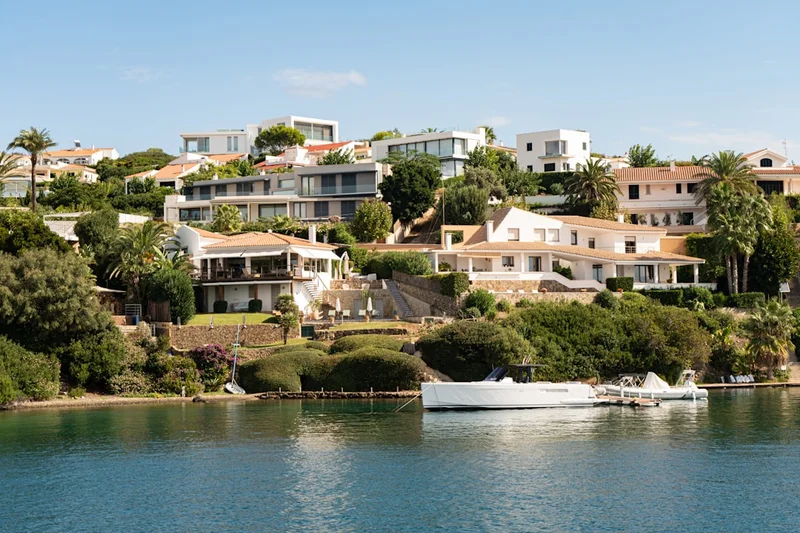 Modern houses on a hillside overlooking the water